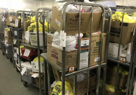 A picture of boxes of food stacked in preparation for meal distribution