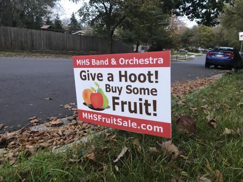 A yard sign that read: "MHS Band & Orchestra, Give a Hoot! Buy some Fruit! MHSFruitSale.com"