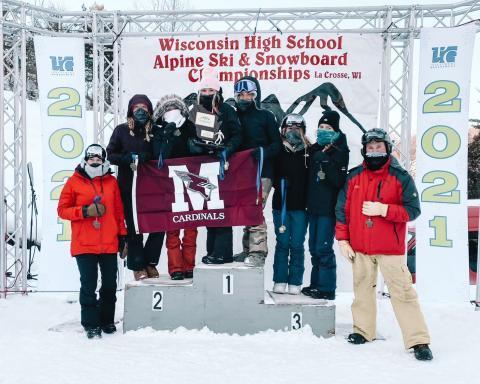 MCPASD girls' alpine ski and snowboard team receives a trophy for winning the championship.