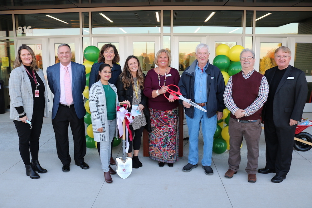 Board of education holding the ribbon cutting scissors 