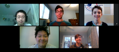 Multiple students appear on a Zoom call looking excited and happy.